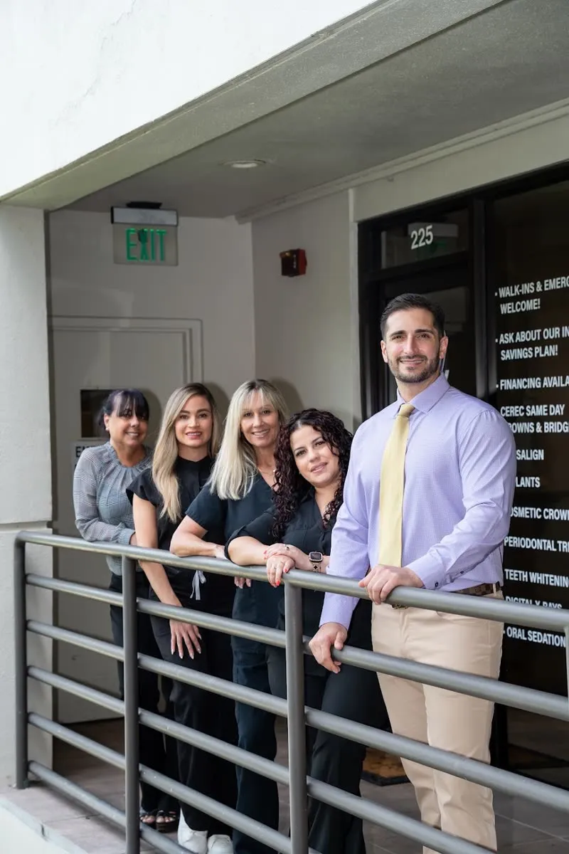 Dentist and team standing on the balcony of a dental office